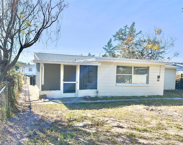 rear view of house featuring a yard