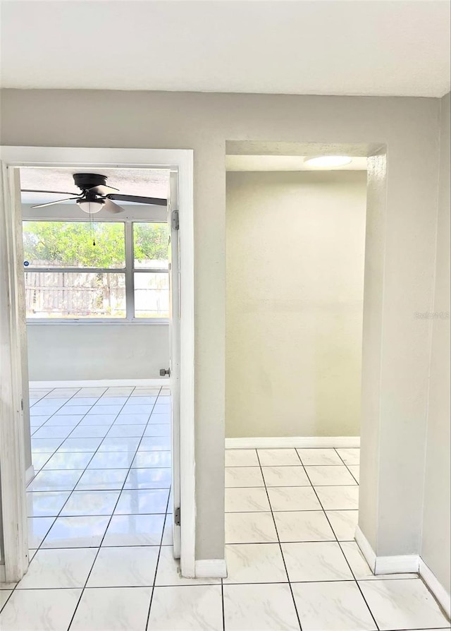 entryway with light tile patterned floors and ceiling fan