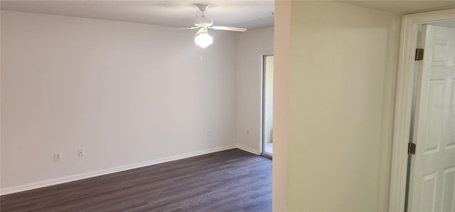 spare room with dark wood-type flooring and ceiling fan