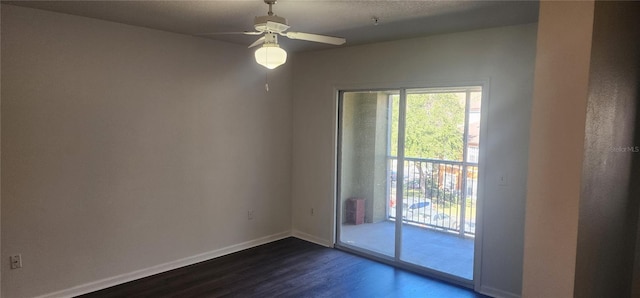 spare room featuring dark hardwood / wood-style floors and ceiling fan