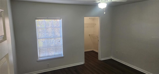 spare room with dark wood-type flooring and ceiling fan