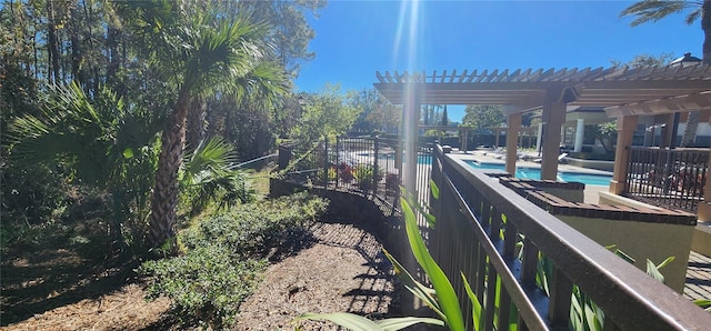 exterior space featuring a fenced in pool and a pergola