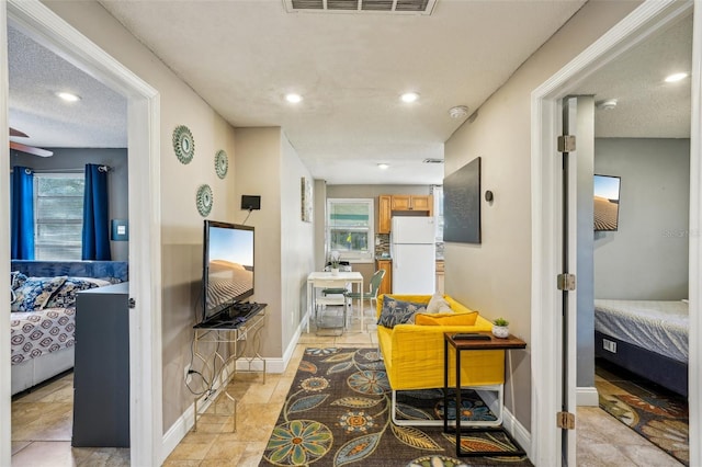 hallway with a textured ceiling