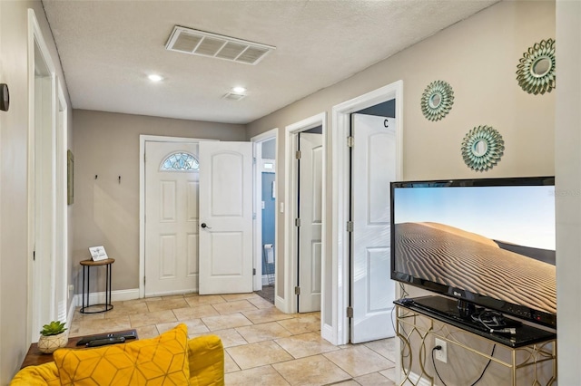 foyer entrance featuring light tile patterned floors