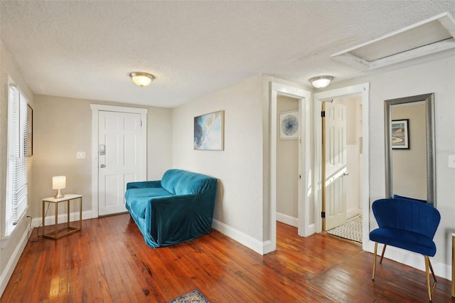 sitting room with dark hardwood / wood-style flooring and a textured ceiling