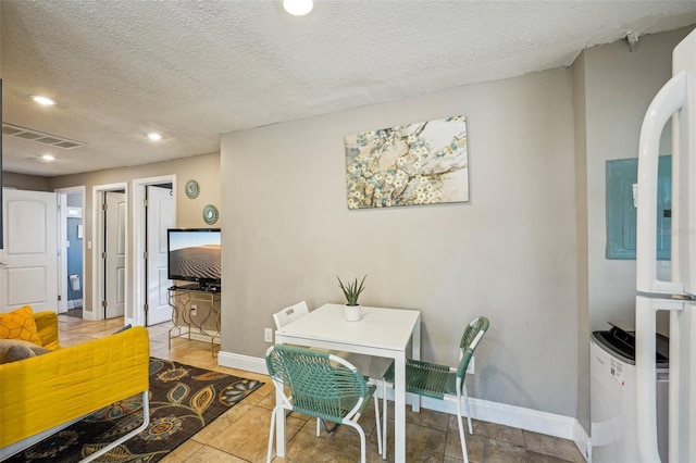 dining space featuring a textured ceiling