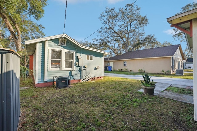 exterior space featuring a yard and cooling unit