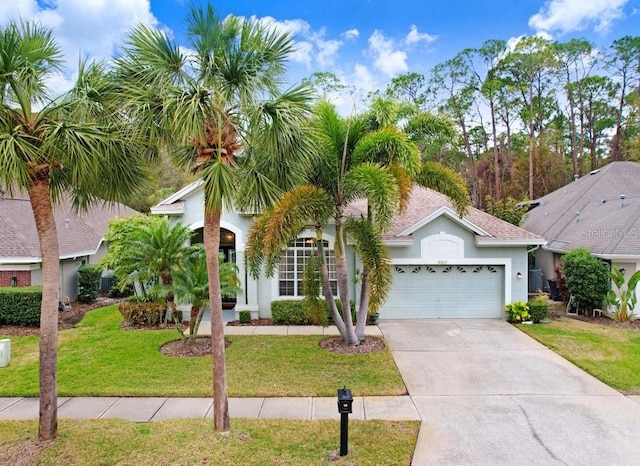 view of front of home featuring a garage and a front yard