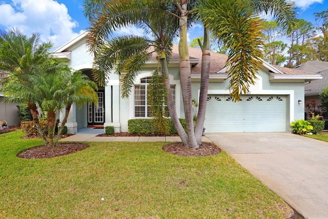 view of front of house with a garage and a front lawn