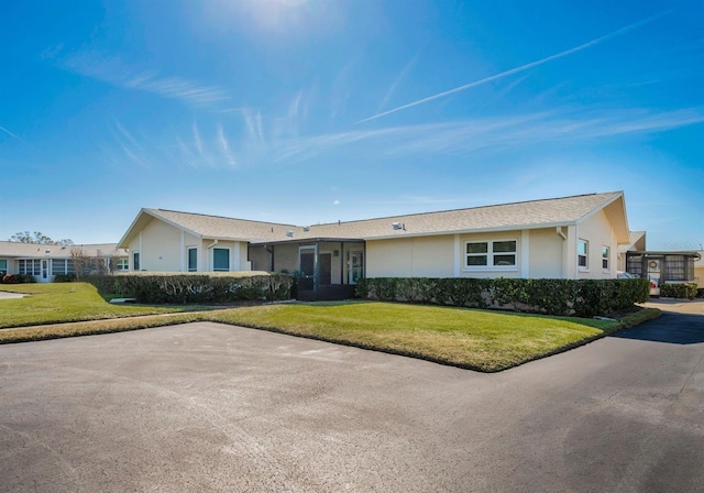 ranch-style home with a front yard