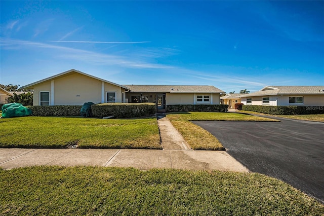 ranch-style home with a front yard