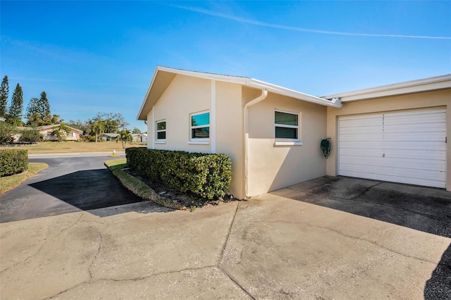 view of side of home featuring a garage