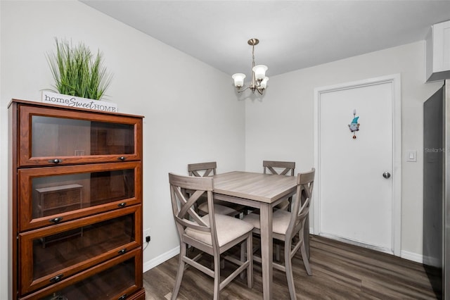 dining area featuring an inviting chandelier and dark wood-type flooring