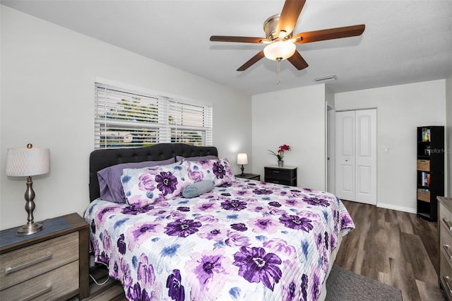 bedroom featuring dark hardwood / wood-style floors, ceiling fan, and a closet