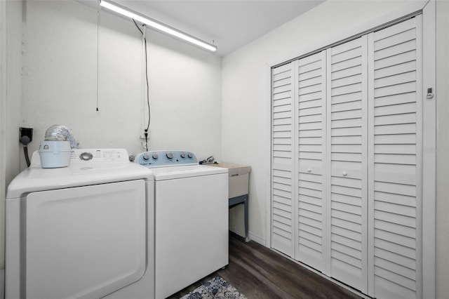 laundry room with separate washer and dryer and dark wood-type flooring