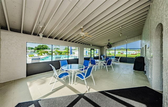 sunroom featuring vaulted ceiling