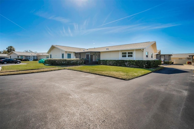 ranch-style home with a front yard