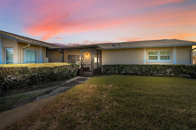 ranch-style home with a yard