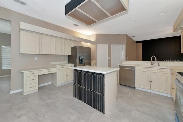 kitchen with stainless steel appliances, extractor fan, a kitchen island, and sink