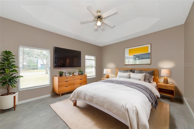 bedroom featuring a raised ceiling and ceiling fan