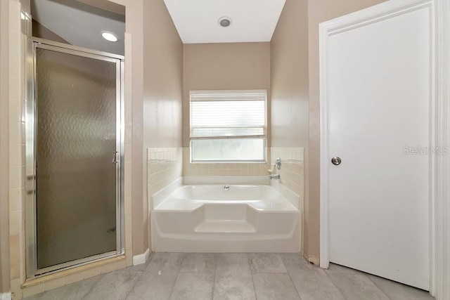 bathroom featuring separate shower and tub