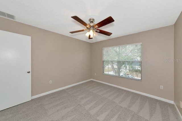 empty room with light carpet and ceiling fan