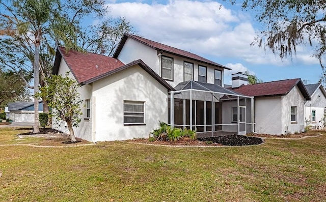 back of house with a lanai and a lawn