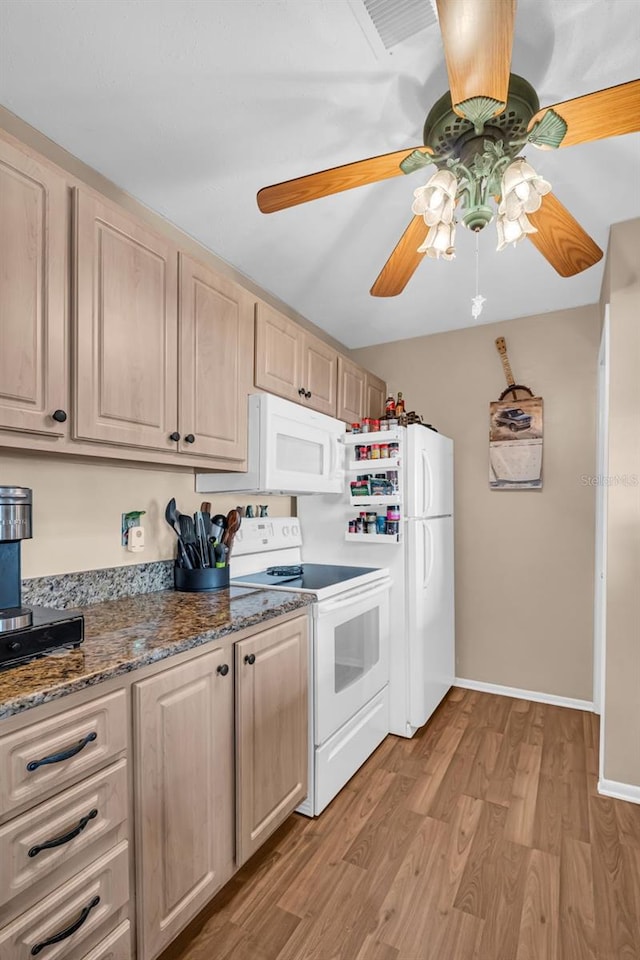 kitchen featuring white appliances, dark stone countertops, light brown cabinets, ceiling fan, and light hardwood / wood-style floors