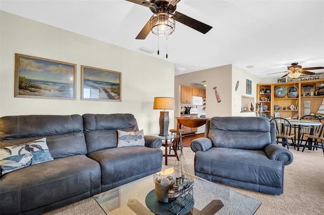 living room featuring carpet floors and ceiling fan