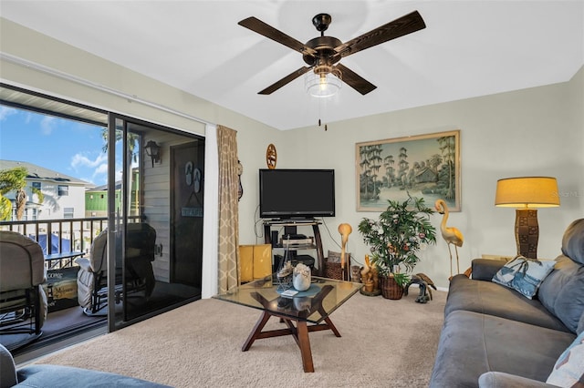 living room with ceiling fan and carpet flooring