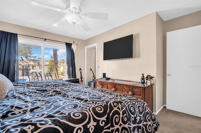 carpeted bedroom featuring ceiling fan, access to exterior, and a textured ceiling