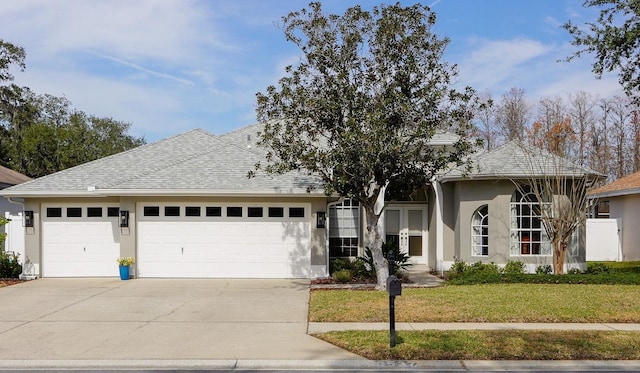 view of front of home featuring a garage and a front lawn