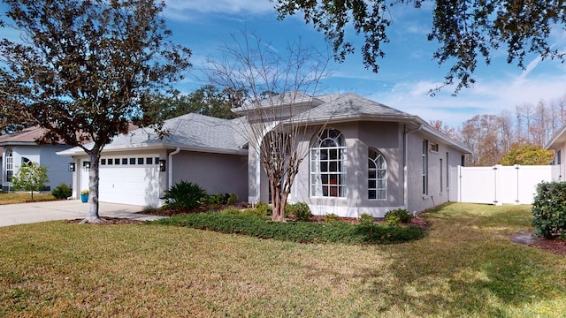 view of front of property with a garage and a front lawn