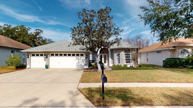 ranch-style home featuring a garage and a front yard