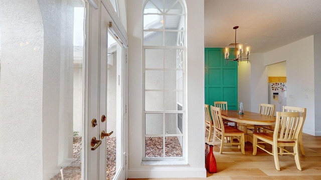 dining room with a notable chandelier and light hardwood / wood-style flooring