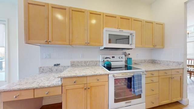 kitchen featuring light brown cabinetry, backsplash, white appliances, and light stone counters