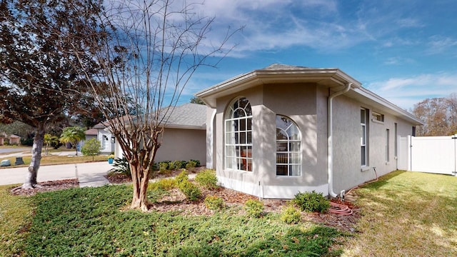 view of side of home with a yard