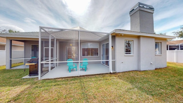 rear view of house featuring a yard, a lanai, and a patio