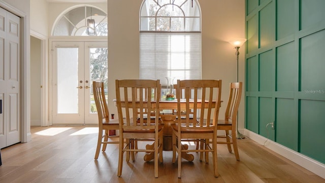 dining room with french doors and light wood-type flooring