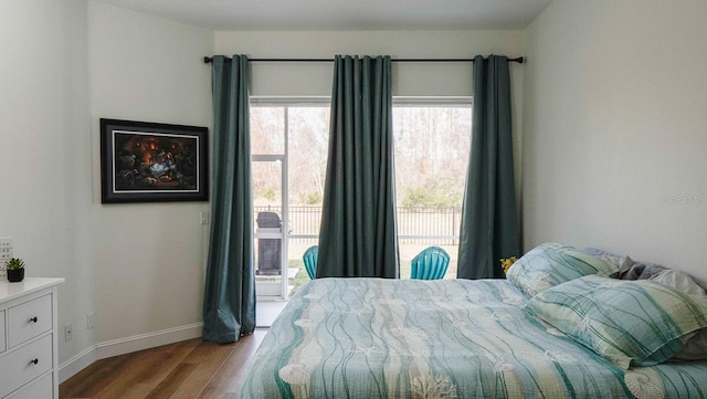 bedroom with access to outside and light hardwood / wood-style floors