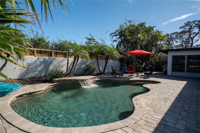 view of pool featuring pool water feature and a patio