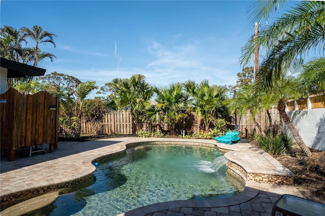 view of swimming pool with a patio and pool water feature