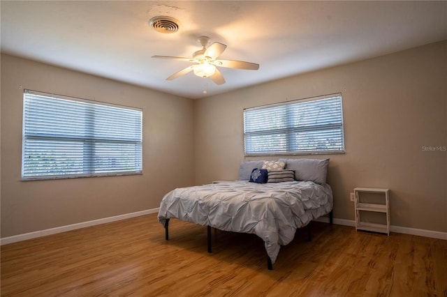 bedroom with wood-type flooring and ceiling fan