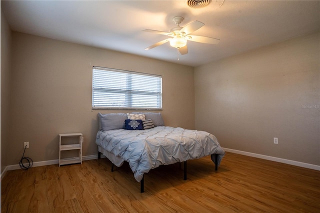 bedroom with ceiling fan and hardwood / wood-style floors