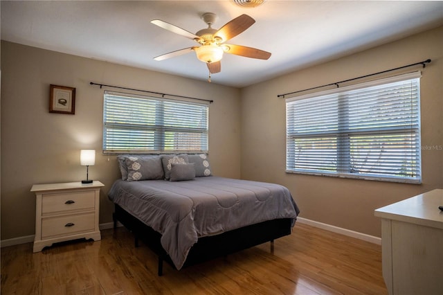 bedroom with ceiling fan and light hardwood / wood-style floors