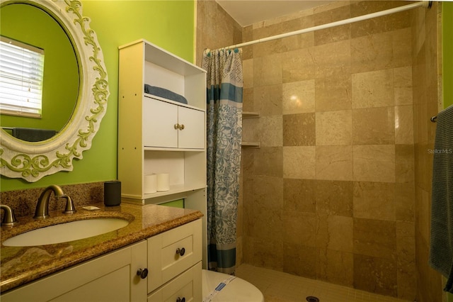 bathroom with vanity, toilet, and curtained shower