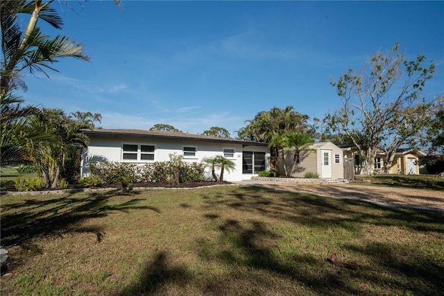 ranch-style home featuring an outbuilding and a front yard