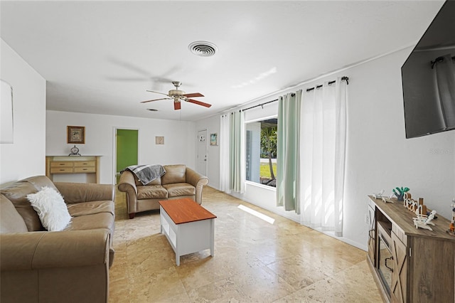 1309 Nokomis Ave S, Venice, FL 34285 - living room featuring a ceiling fan and baseboards