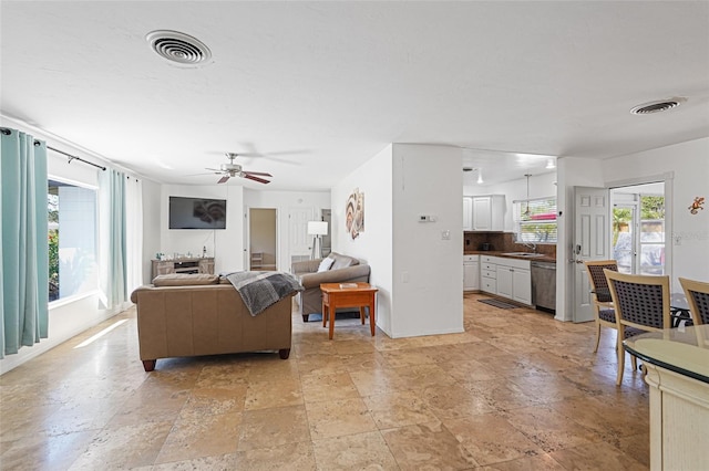 1309 Nokomis Ave S, Venice, FL 34285 - living area with ceiling fan and stone tile flooring