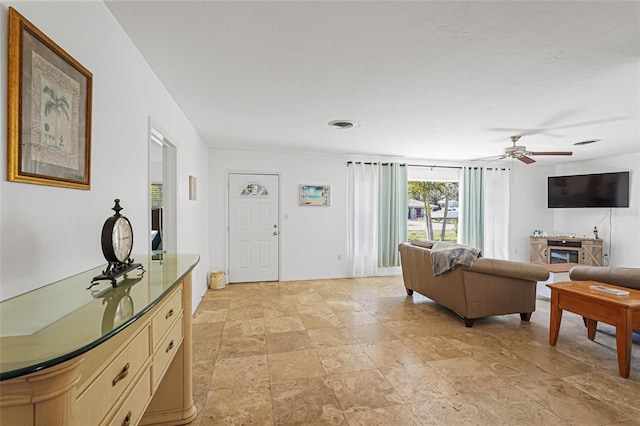 1309 Nokomis Ave S, Venice, FL 34285 - living room featuring light stone finish floors and a ceiling fan